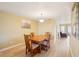 Cozy dining room with a wooden table, four chairs, laminate flooring, and natural light at 334 Club Manor Dr, Sun City Center, FL 33573