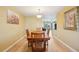 Inviting dining room with a spacious wooden table and a view of the living area at 334 Club Manor Dr, Sun City Center, FL 33573