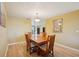 Traditional dining room with light hardwood floors and a wooden table set with a view to the other rooms at 334 Club Manor Dr, Sun City Center, FL 33573