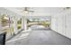 Bright enclosed porch with large windows, a ceiling fan and storage closets at 334 Club Manor Dr, Sun City Center, FL 33573