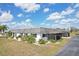Spacious back of home with mature landscaping and a screened in patio at 334 Club Manor Dr, Sun City Center, FL 33573