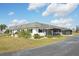 Beautiful single-story home with a well-maintained lawn, covered lanai, and an asphalt driveway at 334 Club Manor Dr, Sun City Center, FL 33573