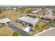 Bird's eye view of a well-maintained home with a two-car garage, a mature lawn, and tropical landscaping at 334 Club Manor Dr, Sun City Center, FL 33573