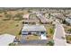 An aerial view shows a cute, single-story home with a long driveway and tropical landscaping in a quiet neighborhood at 334 Club Manor Dr, Sun City Center, FL 33573