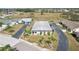 An aerial view of a well-kept home with a mature lawn and tropical landscaping in a tranquil residential neighborhood at 334 Club Manor Dr, Sun City Center, FL 33573