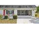 Inviting front porch with seating area and screened garage, perfect for enjoying the outdoors at 334 Club Manor Dr, Sun City Center, FL 33573