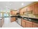Traditional-style kitchen with stainless steel appliances, wood cabinets, and granite countertops at 334 Club Manor Dr, Sun City Center, FL 33573