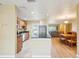 Open kitchen features stainless steel appliances and breakfast bar and a view to the dining room at 334 Club Manor Dr, Sun City Center, FL 33573