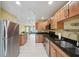 Bright kitchen showcasing stainless steel appliances, granite countertops, and tile flooring at 334 Club Manor Dr, Sun City Center, FL 33573