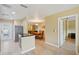 Open concept kitchen features wood cabinets and a breakfast bar with a view of the dining room at 334 Club Manor Dr, Sun City Center, FL 33573