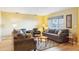 Well-lit living room with comfortable sofas, accent chairs, and stylish decor at 334 Club Manor Dr, Sun City Center, FL 33573