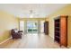 Spacious living room with wood floors and sliding glass doors leading to the patio at 334 Club Manor Dr, Sun City Center, FL 33573