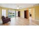 Bright living room featuring wood floors, a ceiling fan, and sliding glass doors at 334 Club Manor Dr, Sun City Center, FL 33573