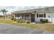 Exterior view of house showing the screened lanai and well-kept lawn at 334 Club Manor Dr, Sun City Center, FL 33573