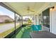 The screened-in lanai features a ceiling fan and outdoor seating at 334 Club Manor Dr, Sun City Center, FL 33573