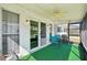 Screened-in porch area with a ceiling fan, table, and chairs for relaxing outdoors at 334 Club Manor Dr, Sun City Center, FL 33573