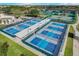 Aerial view of tennis and pickleball courts with many participants at 334 Club Manor Dr, Sun City Center, FL 33573