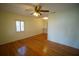 Sunlit living room showcasing hardwood floors, a ceiling fan, and bright, neutral walls at 3612 W Tampa Cir, Tampa, FL 33629