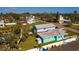 Backyard aerial shot featuring a turquoise home with a flat roof and a backyard fence at 3774 Arkansas Ne Ave, St Petersburg, FL 33703