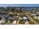 Residential street with turquoise house, lake backdrop and city skyline in the distance at 3774 Arkansas Ne Ave, St Petersburg, FL 33703