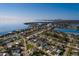 Scenic aerial view of a waterfront neighborhood showcasing a charming turquoise home with beautiful waterfront views at 3774 Arkansas Ne Ave, St Petersburg, FL 33703