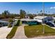 Ariel view of a single-story home showcasing its manicured lawn and a charming fenced yard at 3774 Arkansas Ne Ave, St Petersburg, FL 33703