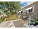 Cozy backyard and patio featuring a mature shade tree perfect for outdoor entertaining and leisure at 37841 Mission Hills Ave, Zephyrhills, FL 33541