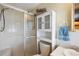 This bathroom features a shower with sliding doors and a linen cabinet for storage space at 37841 Mission Hills Ave, Zephyrhills, FL 33541