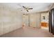 Spacious bedroom offering carpeted floors, ceiling fan, and a door to the bathroom for privacy at 37841 Mission Hills Ave, Zephyrhills, FL 33541