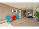 Spacious carport area, featuring a golf cart and outdoor seating at 37841 Mission Hills Ave, Zephyrhills, FL 33541