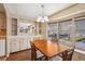 Cozy dining room features a wooden table, built-in cabinet with a mirror, and lots of natural light at 37841 Mission Hills Ave, Zephyrhills, FL 33541