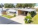 Charming home with a covered parking area, showcasing well-maintained landscaping at 37841 Mission Hills Ave, Zephyrhills, FL 33541