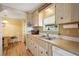 Charming kitchen featuring classic cabinetry and stainless steel sink at 37841 Mission Hills Ave, Zephyrhills, FL 33541