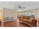Comfortable living room showcases laminate floors, ceiling fan and a large window that floods the space with light at 37841 Mission Hills Ave, Zephyrhills, FL 33541