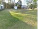 Expansive backyard featuring lush green grass and mature trees at 39349 & 39343 Rusbe Dr, Zephyrhills, FL 33540