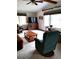 Comfortable living room with ceiling fan, mounted television, and light-filled windows with natural light at 39349 & 39343 Rusbe Dr, Zephyrhills, FL 33540