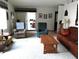 Cozy living room featuring comfortable seating, neutral carpet, and natural light from sliding door to outdoor area at 39349 & 39343 Rusbe Dr, Zephyrhills, FL 33540