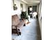 Enclosed porch featuring natural light and concrete flooring, ideal for relaxation with a bench and outdoor seating at 39349 & 39343 Rusbe Dr, Zephyrhills, FL 33540