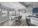 Bright dining room with modern chandelier, water view, and a white marble table with seating for six at 4195 Des Prez Ct, Hernando Beach, FL 34607