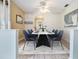 Elegant dining room featuring a modern table with seating for six and a decorative ceiling fan at 4408 W Lackland Pl, Tampa, FL 33616