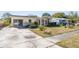 Charming single-story home with a yellow exterior, stone accents, and a spacious driveway at 4408 W Lackland Pl, Tampa, FL 33616