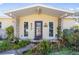 Inviting front porch showcasing stone accents, a decorative door, and manicured landscaping at 4408 W Lackland Pl, Tampa, FL 33616
