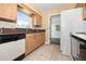 This kitchen features wooden cabinets, tile countertops, and tile flooring at 4408 W Lackland Pl, Tampa, FL 33616