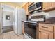 This kitchen features wooden cabinets, tile countertops, and tile flooring at 4408 W Lackland Pl, Tampa, FL 33616