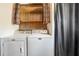 Convenient laundry room with washer, dryer and overhead shelving at 4408 W Lackland Pl, Tampa, FL 33616