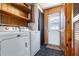 Functional laundry area with appliances, shelving and access to outdoors at 4408 W Lackland Pl, Tampa, FL 33616