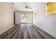 Bright living room featuring modern vinyl plank flooring and a ceiling fan at 4408 W Lackland Pl, Tampa, FL 33616
