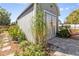 Side view of backyard outbuilding, which has a small stone pathway leading to the front doors at 4408 W Lackland Pl, Tampa, FL 33616