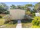 An exterior view of the backyard outbuilding with a small stone path leading to the front doors at 4408 W Lackland Pl, Tampa, FL 33616