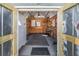 View inside the outbuilding, with a workbench, ceiling fan, and plenty of storage at 4408 W Lackland Pl, Tampa, FL 33616